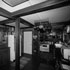 Wider angle view of the original kitchen and dining area with post in center