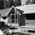 Creekside view of the cabin with the addition framed